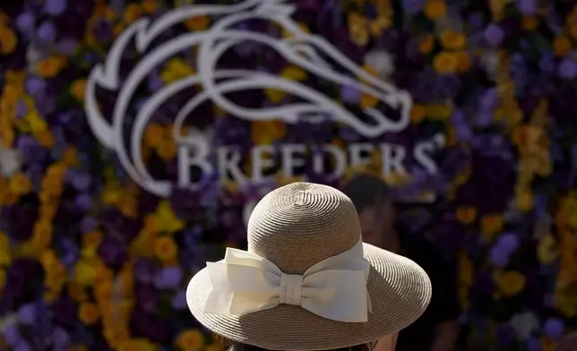 A woman is shown at Santa Anita Park for Breeders' Cup horse racing in Del Mar, Calif., Friday, Nov. 1, 2024. (AP Photo/Gregory Bull)