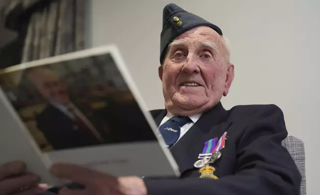 Michael Woods, 100-year-old World War II veteran, poses for a photograph during an interview in Dunstable, Bedfordshire, England, Tuesday, Nov. 5, 2024. (AP Photo/Kin Cheung)