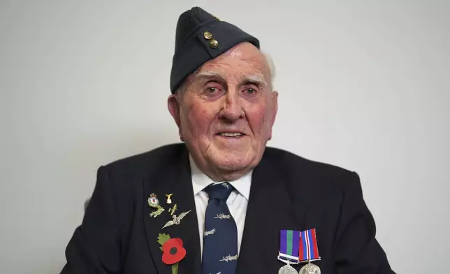 Michael Woods, 100-year-old World War II veteran, poses for a photograph during an interview in Dunstable, Bedfordshire, England, Tuesday, Nov. 5, 2024. (AP Photo/Kin Cheung)