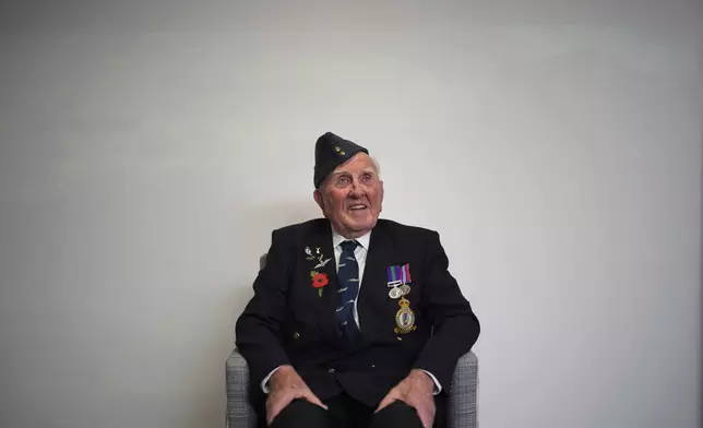 Michael Woods, 100-year-old World War II veteran, poses for a photograph during an interview in Dunstable, Bedfordshire, England, Tuesday, Nov. 5, 2024. (AP Photo/Kin Cheung)