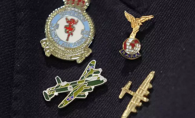 Michael Woods, 100-year-old World War II veteran wears a pin featuring a Lancaster Bomber during an interview in Dunstable, Bedfordshire, England, Tuesday, Nov. 5, 2024. (AP Photo/Kin Cheung)