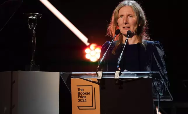 Samantha Harvey speaks on stage after winning the Booker Prize award 2024, in London, Tuesday, Nov. 12, 2024. (AP Photo/Alberto Pezzali)