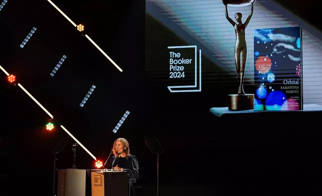 Samantha Harvey speaks on stage after winning the Booker Prize award 2024, in London, Tuesday, Nov. 12, 2024. (AP Photo/Alberto Pezzali)