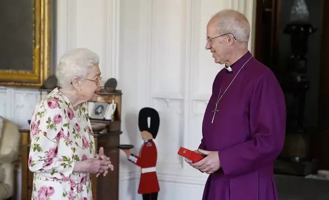 FILE - Britain's Queen Elizabeth II receives the Archbishop of Canterbury Justin Welby at Windsor Castle, Windsor, England, Tuesday June 21, 2022, where he presented the Queen with a special 'Canterbury Cross' for her unstinting service to the Church of England over seventy years and a citation for the Cross, which was presented as a framed piece of calligraphy. (Andrew Matthews/Pool via AP, File)