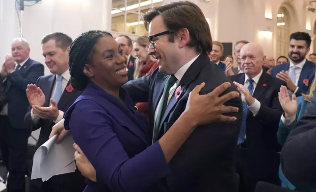 Britain's Member of Parliament Kemi Badenoch, left, embraces her husband Hamish Badenoch after being elected as the new leader of the opposition Conservative Party, in London, Saturday, Nov. 2, 2024. (AP Photo/Alberto Pezzali)