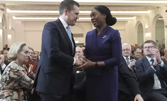 Britain's Member of Parliament Kemi Badenoch is congratulated by Robert Jenrick after being announced as the new Conservative Party leader following the vote by party members, at 8 Northumberland Avenue in central London, Saturday Nov. 2, 2024. (Stefan Rousseau/PA via AP)