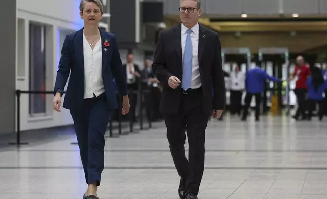 British Prime Minister Keir Starmer, right, and Home Secretary Yvette Cooper, left, walk at the Interpol General Assembly in Glasgow, Scotland, Britain, Monday, Nov. 4, 2024. (Russell Cheyne/Pool Photo via AP)