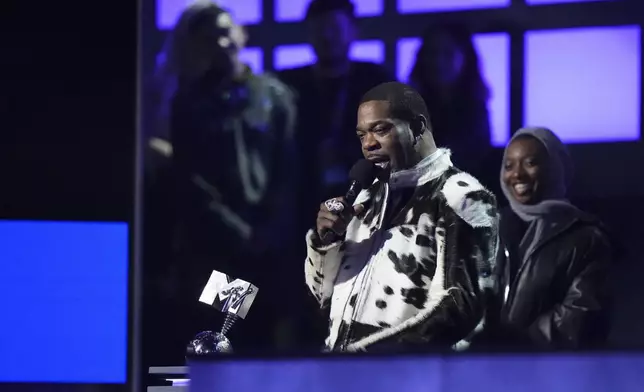 Busta Rhymes, front, accepts the 2024 MTV EMAs global icon award presented by Little Simz during the MTV European Music Awards in Manchester, England, Sunday, Nov. 10, 2024. (Scott A Garfitt/Invision/AP)