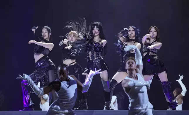 Kazuha, from left, Sakura Miyawaki, Hong Eunchae, Huh Yunjin, and Kim Chaewon, from the group 'Le Sserafim' perform during the MTV European Music Awards in Manchester, England, Sunday, Nov. 10, 2024. (Scott A Garfitt/Invision/AP)