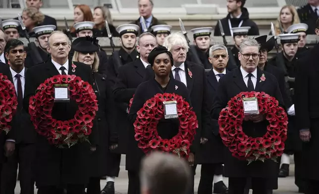 From left: Britain's former Prime Minister Rishi Sunak, Liberal Democrat leader Sir Ed Davey, former Prime Minister Liz Truss, leader of the opposition Kemi Badenoch, former Prime Minister Boris Johnson, Mayor of London Sadiq Khan and Prime Minister Sir Keir Starmer attend the National Service of Remembrance at The Cenotaph in London, England, Sunday, Nov. 10, 2024. (Aaron Chown/PA via AP)