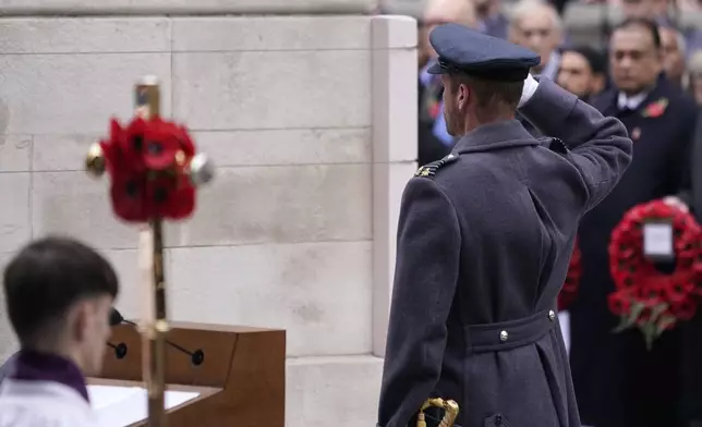 Britain's Prince William salutes after laying a wreath during the Remembrance Sunday Service at the Cenotaph in London, Sunday, Nov. 10, 2024. (AP Photo/Alberto Pezzali, Pool)