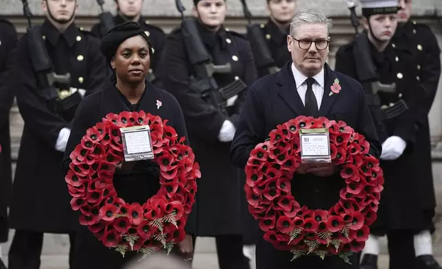 Britain's leader of the opposition Kemi Badenoch, left, and Prime Minister Sir Keir Starmer attend the National Service of Remembrance at The Cenotaph in London, England, Sunday, Nov. 10, 2024. (Aaron Chown/PA via AP)