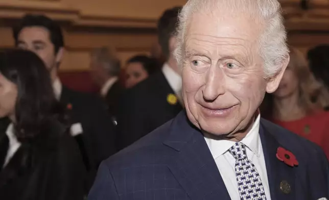 Britain's King Charles III meets guests during an International Sustainability reception at Buckingham Palace in London, Wednesday Nov. 6, 2024. (Jordan Pettitt/Pool via AP)