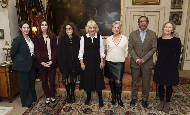 From left, Yael van der Wouden, Rachel Kushner, Anne Michaels, Britain's Queen Camilla, Charlotte Wood, Percival Everett, and Samantha Harvey pose during a reception for the Booker Prize Foundation at Clarence House, London, Tuesday Nov. 12, 2024. (Aaron Chown, Pool Photo via AP)