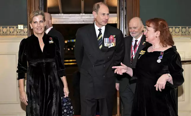 Prince Edward, Duke of Edinburgh, center, and Sophie, Duchess of Edinburgh, left, attend the Royal British Legion Festival of Remembrance at the Royal Albert Hall in London, Saturday Nov. 9, 2024. (Chris J. Ratcliffe/Pool Photo via AP)