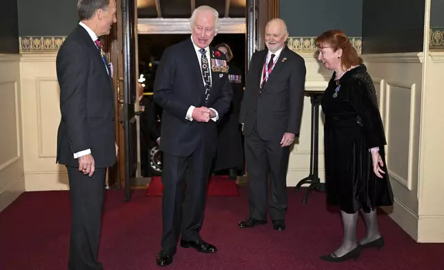 Britain's King Charles, centre left, arrives to attend the Royal British Legion Festival of Remembrance at the Royal Albert Hall in London, Saturday Nov. 9, 2024. (Chris J. Ratcliffe/Pool Photo via AP)