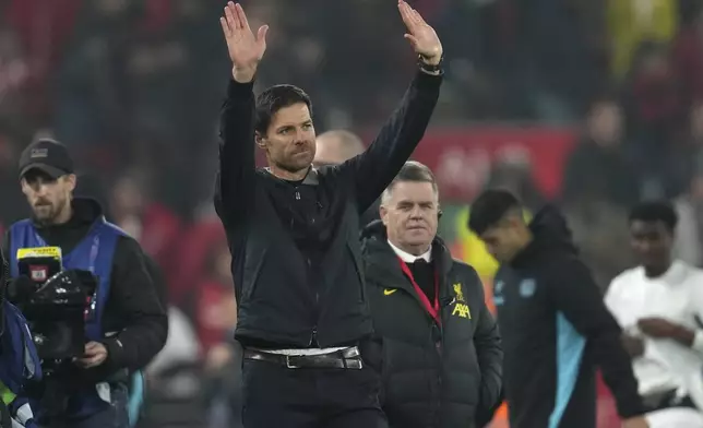 Leverkusen's head coach Xabi Alonso waves to the crowd at the end of the Champions League opening phase soccer match between Liverpool and Bayer Leverkusen at Anfield in Liverpool, England, Tuesday, Nov. 5, 2024. (AP Photo/Jon Super)