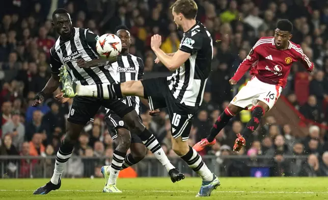 Manchester United's Amad Diallo, right, scores his side's second goal during the Europa League opening phase soccer match between Manchester United and PAOK at the Old Trafford stadium in Manchester, England, Thursday, Nov. 7, 2024. (AP Photo/Dave Thompson)