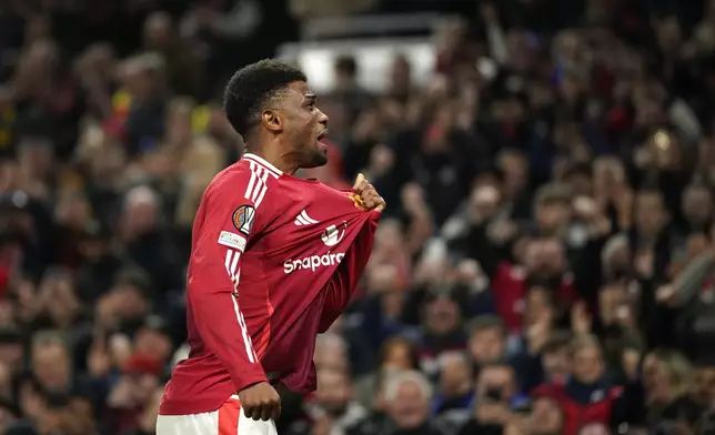 Manchester United's Amad Diallo celebrates after scoring his side's second goal during the Europa League opening phase soccer match between Manchester United and PAOK at the Old Trafford stadium in Manchester, England, Thursday, Nov. 7, 2024. (AP Photo/Dave Thompson)