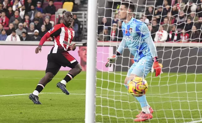 Brentford's Yoane Wissa, left, celebrates scoring their side's first goal of the game during the Premier League match at the Gtech Community Stadium, London, Saturday Nov. 9, 2024. (John Walton/PA via AP)