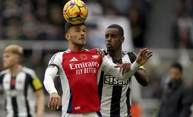 Arsenal's Ben White, left and Newcastle United's Alexander Isak vie for the ball, during the English Premier League soccer match between Newcastle United and Arsenal, at St James' Park, in Newcastle, England, Saturday, Nov. 2, 2024. (Owen Humphreys/PA via AP)