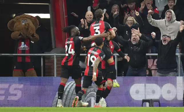 Bournemouth's Evanilson is mobbed by teammates after scoring his sides second goal during the English Premier League soccer match between Bournemouth and Manchester City at the Vitality stadium in Bournemouth, England, Saturday, Nov. 2, 2024. (AP Photo/Kirsty Wigglesworth)