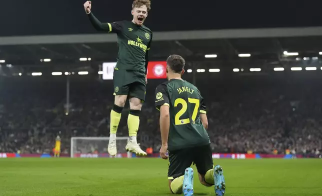 Brentford's Vitaly Janelt, right, celebrates with teammate Brentford's Keane Lewis-Potter after scoring the opening goal of the game during the English Premier League soccer match between Fulham and Brentford at Craven Cottage stadium in London, Monday, Nov. 4, 2024. (AP Photo/Frank Augstein)