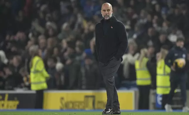 Manchester City's head coach Pep Guardiola leaves the pitch after the English Premier League soccer match between Brighton and Manchester City at Falmer Stadium in Brighton, England, Saturday, Nov. 9, 2024. (AP Photo/Alastair Grant)