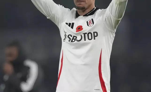 Fulham's Tom Cairney celebrates towards the fans after the end of the English Premier League soccer match between Fulham and Brentford at Craven Cottage stadium in London, Monday, Nov. 4, 2024, Fulham won thematic 2-1. (AP Photo/Frank Augstein)