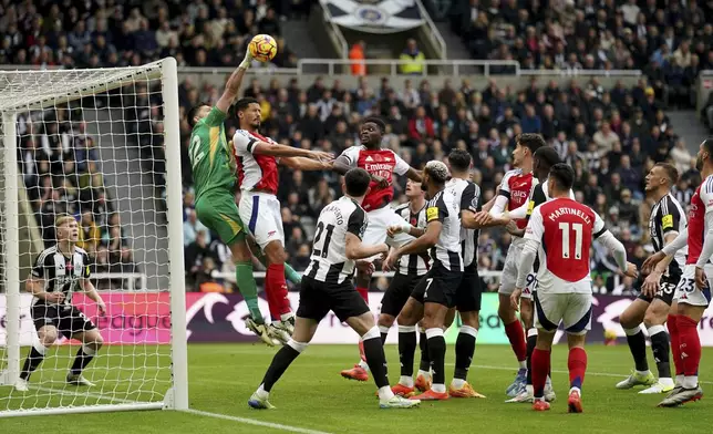 Newcastle United's goalkeeper Nick Pope clears the ball from a corner, during the English Premier League soccer match between Newcastle United and Arsenal, at St James' Park, in Newcastle, Saturday, Nov. 2, 2024. (Owen Humphreys/PA via AP)