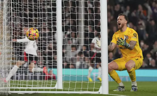 Brentford's goalkeeper Mark Flekken reacts after conceding a goal scored by Fulham's Harry Wilson, his sides first goal, during the English Premier League soccer match between Fulham and Brentford at Craven Cottage stadium in London, Monday, Nov. 4, 2024. (AP Photo/Frank Augstein)