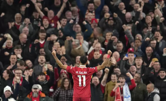 Liverpool's Mohamed Salah celebrates after scoring his side's second goal during the English Premier League soccer match between Liverpool and Brighton at the Anfield stadium in Liverpool, England, Saturday, Nov. 2, 2024. (AP Photo/Jon Super)