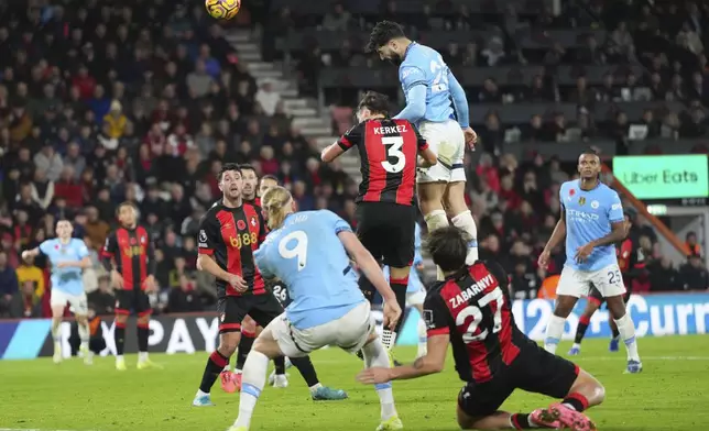 Manchester City's Josko Gvardiol, top right, heads the ball and scores his sides first goal during the English Premier League soccer match between Bournemouth and Manchester City at the Vitality stadium in Bournemouth, England, Saturday, Nov. 2, 2024. (AP Photo/Kirsty Wigglesworth)