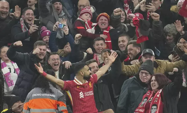 Liverpool's Mohamed Salah celebrates after scoring his side's 2nd goal against Aston Villa during the English Premier League soccer match at the Anfield stadium in Liverpool, Saturday, Nov. 9, 2024. (AP Photo/Jon Super)