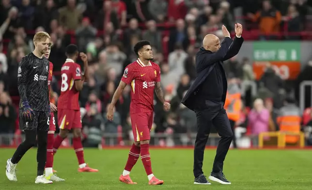 Liverpool's manager Arne Slot, right, celebrates with his players after winning the English Premier League soccer match between Liverpool and Brighton at the Anfield stadium in Liverpool, England, Saturday, Nov. 2, 2024. Liverpool won 2-1.(AP Photo/Jon Super)