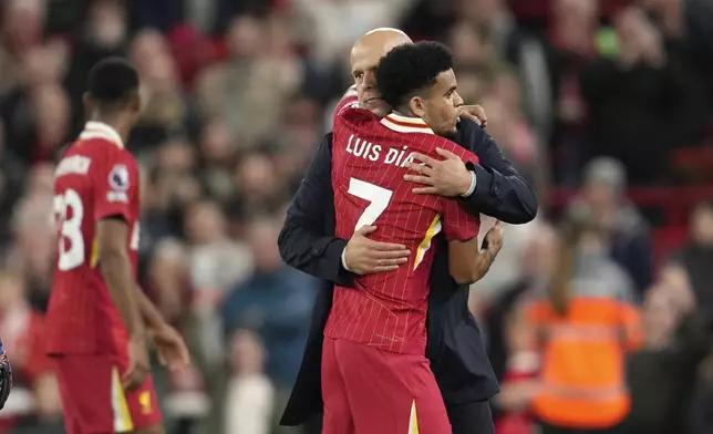 Liverpool's manager Arne Slot, right, celebrates with his player Luis Diaz after winning the English Premier League soccer match between Liverpool and Brighton at the Anfield stadium in Liverpool, England, Saturday, Nov. 2, 2024. Liverpool won 2-1.(AP Photo/Jon Super)