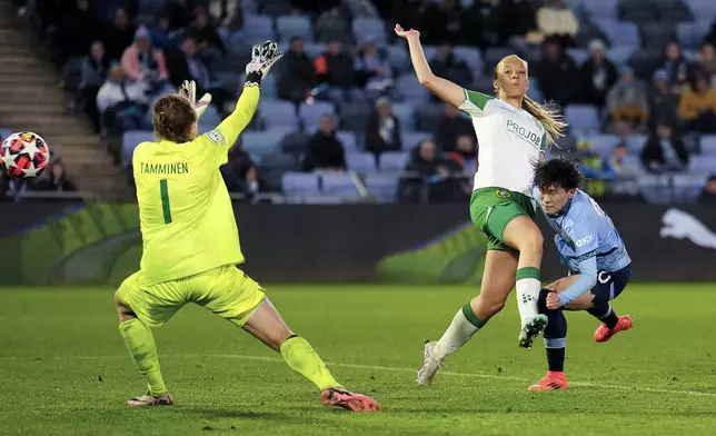 Manchester City's Aoba Fujino, right, scores her side's second goal during the women's Champions League soccer match between Manchester City FC and Hammarby IF in Manchester, England, Tuesday, Nov. 12, 2024. (Martin Rickett/PA via AP)