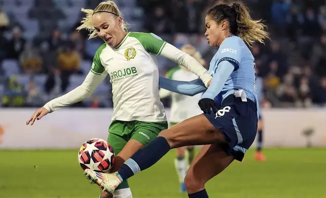 Manchester City's Mary Fowler, right, and Hammaby IF's Stina Lennartsson, left, challenge for the ball during the women's Champions League soccer match between Manchester City FC and Hammarby IF in Manchester, England, Tuesday, Nov. 12, 2024. (Martin Rickett/PA via AP)