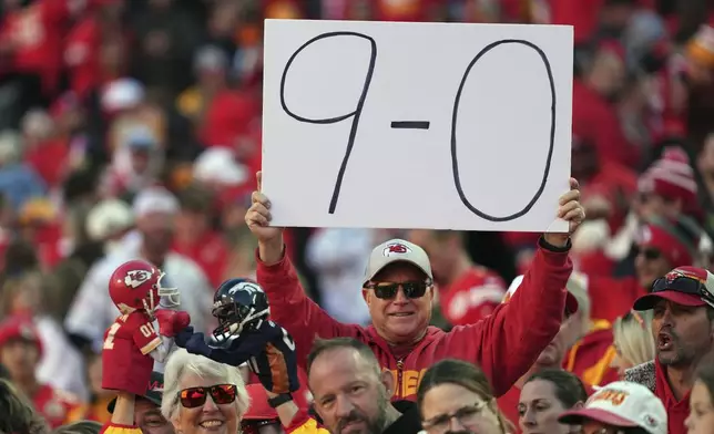 A fan holds up a sign following an NFL football game between the Kansas City Chiefs and the Denver Broncos Sunday, Nov. 10, 2024, in Kansas City, Mo. The Chiefs won 16-14. (AP Photo/Charlie Riedel)