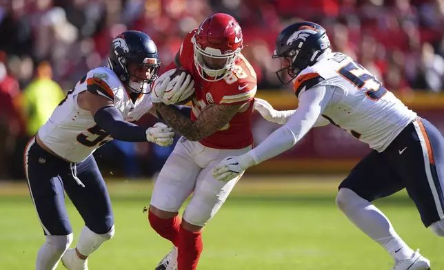 Kansas City Chiefs tight end Peyton Hendershot (88) runs with the ball as Denver Broncos inside linebacker Cody Barton and outside linebacker Jonah Elliss, right, defend during the second half of an NFL football game Sunday, Nov. 10, 2024, in Kansas City, Mo. (AP Photo/Charlie Riedel)