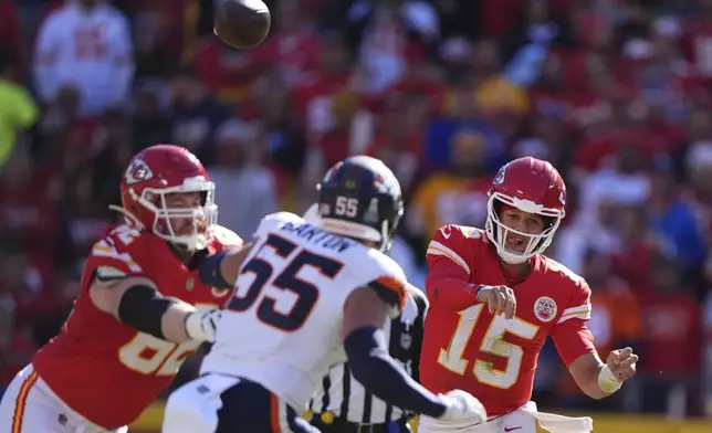 Kansas City Chiefs quarterback Patrick Mahomes (15) throws over Denver Broncos inside linebacker Cody Barton (55) during the first half of an NFL football game Sunday, Nov. 10, 2024, in Kansas City, Mo. (AP Photo/Charlie Riedel)