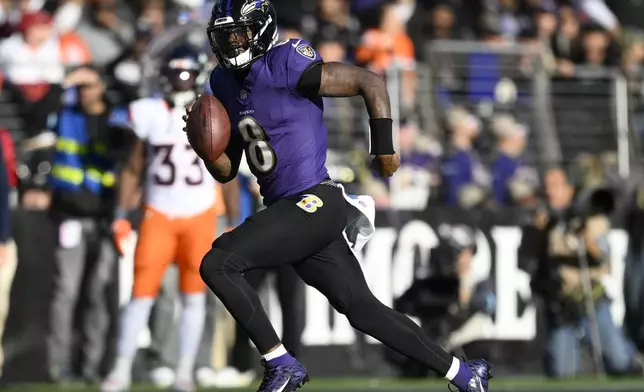 Baltimore Ravens quarterback Lamar Jackson runs with the ball in the second half of an NFL football game against the Denver Broncos in an NFL football game Sunday, Nov. 3, 2024, in Baltimore. (AP Photo/Nick Wass)