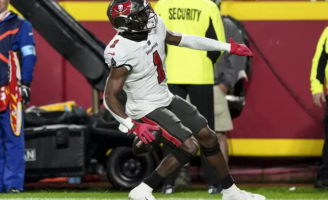 Tampa Bay Buccaneers running back Rachaad White (1) celebrates his touchdown against the Kansas City Chiefs during the first half of an NFL football game, Monday, Nov. 4, 2024, in Kansas City, Mo. (AP Photo/Charlie Riedel)