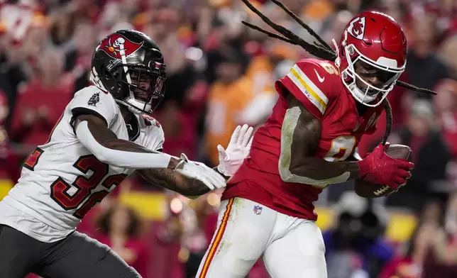 Kansas City Chiefs wide receiver DeAndre Hopkins (8) scores a touchdown against Tampa Bay Buccaneers safety Josh Hayes (32) during the first half of an NFL football game, Monday, Nov. 4, 2024, in Kansas City, Mo. (AP Photo/Ed Zurga)