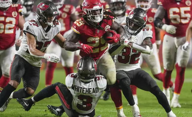 Kansas City Chiefs running back Kareem Hunt (29) runs into Tampa Bay Buccaneers safety Jordan Whitehead (3) during the second half of an NFL football game, Monday, Nov. 4, 2024, in Kansas City, Mo. (AP Photo/Ed Zurga)