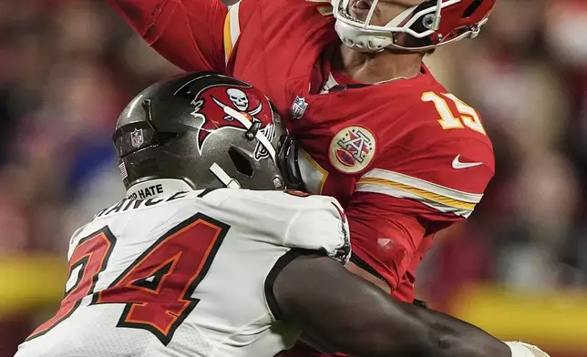 Tampa Bay Buccaneers cornerback Bryce Hall (34) hits Kansas City Chiefs quarterback Patrick Mahomes (15) during the first half of an NFL football game, Monday, Nov. 4, 2024, in Kansas City, Mo. (AP Photo/Charlie Riedel)