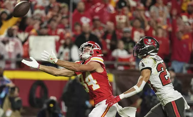 Kansas City Chiefs wide receiver Justin Watson (84) works for a catch against Tampa Bay Buccaneers cornerback Zyon McCollum (27) during the first half of an NFL football game, Monday, Nov. 4, 2024, in Kansas City, Mo. (AP Photo/Charlie Riedel)