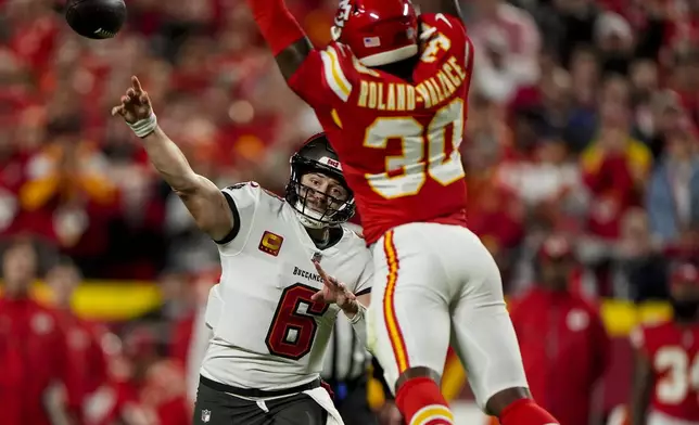 Tampa Bay Buccaneers quarterback Baker Mayfield (6) passes under pressure by Kansas City Chiefs cornerback Christian Roland-Wallace (30) during the first half of an NFL football game, Monday, Nov. 4, 2024, in Kansas City, Mo. (AP Photo/Charlie Riedel)