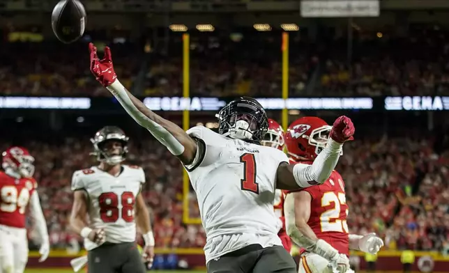 Tampa Bay Buccaneers running back Rachaad White (1) celebrates his touchdown against the Kansas City Chiefs during the first half of an NFL football game, Monday, Nov. 4, 2024, in Kansas City, Mo. (AP Photo/Ed Zurga)