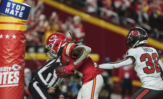 Kansas City Chiefs wide receiver DeAndre Hopkins (8) scores a touchdown against Tampa Bay Buccaneers safety Josh Hayes (32) during the first half of an NFL football game, Monday, Nov. 4, 2024, in Kansas City, Mo. (AP Photo/Charlie Riedel)